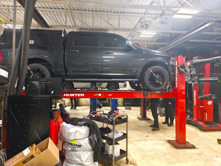 Pickup truck on the Hunter four-post alignment rack in the service bay