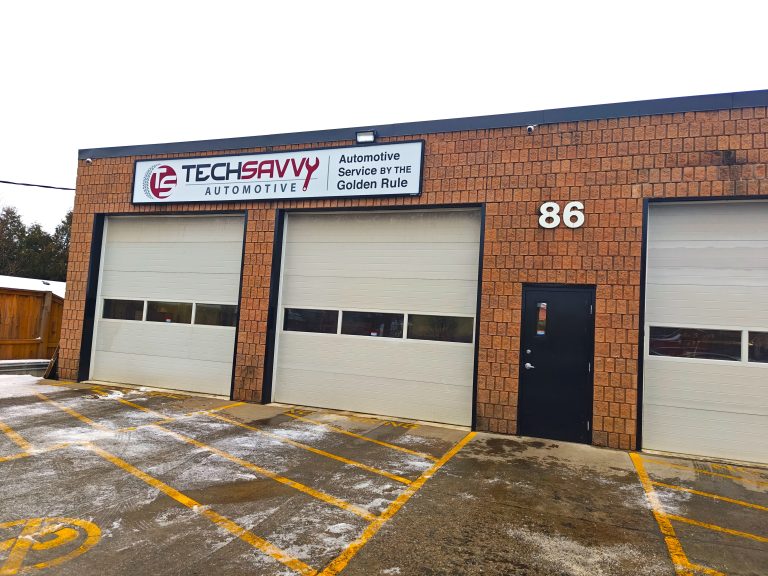 Tech Savvy Automotive at 86 Winniett St in Brantford, three white bay doors below the Golden Rule sign