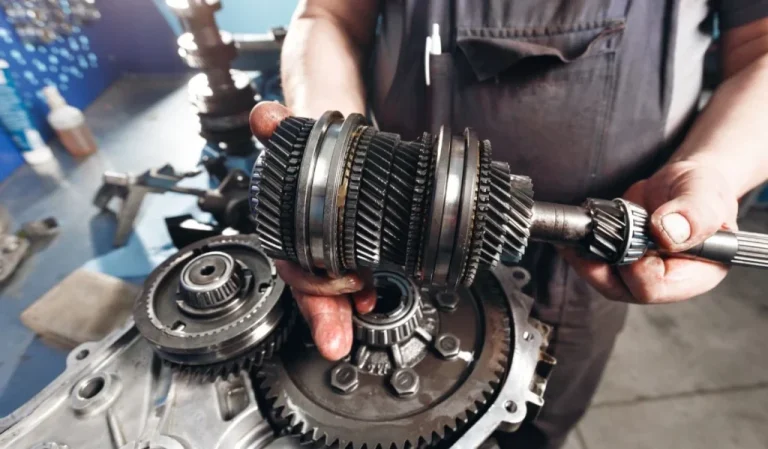 Hands holding a transmission gear cluster