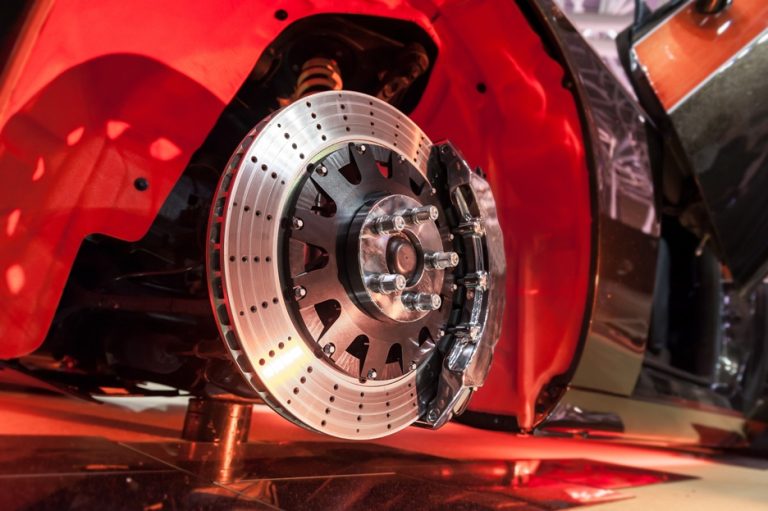 Brake rotor and red caliper in the wheel well