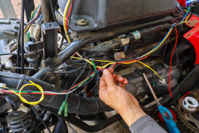 Technician repairing the wiring harness on a powersports vehicle