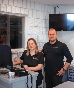 Two Tech Savvy Automotive team members at the reception desk