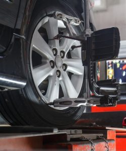 SUV on an alignment rack with a sensor target and monitor