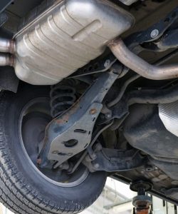 Muffler and exhaust pipe under a lifted vehicle